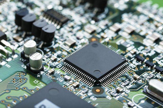 Closeup of electronic circuit board with CPU microchip electronic components background